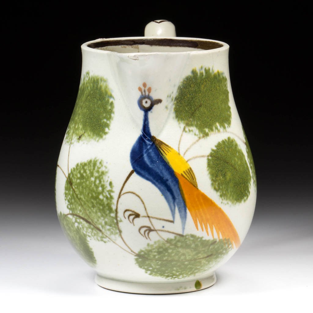 ENGLISH STAFFORDSHIRE POTTERY PEARLWARE DIMINUTIVE: ENGLISH STAFFORDSHIRE POTTERY PEARLWARE DIMINUTIVE PEAFOWL PITCHER, of baluster form, centering a large and colorful peafowl surrounded by brown branches and green-sponged abstract foliage, with a ban