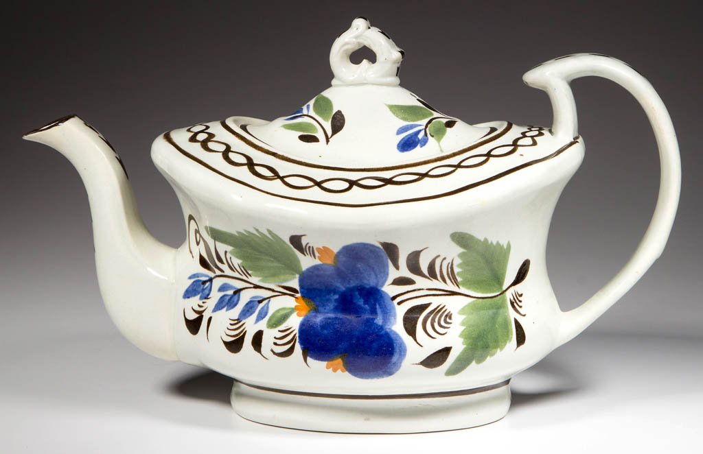 ENGLISH STAFFORDSHIRE POTTERY PEARLWARE FLORAL TEAPOT: ENGLISH STAFFORDSHIRE POTTERY PEARLWARE FLORAL TEAPOT AND COVER, the body of waisted ovular form, with a broad shoulder, issuing the S-form molded spout, and the broad, C-form strap handle attached wi