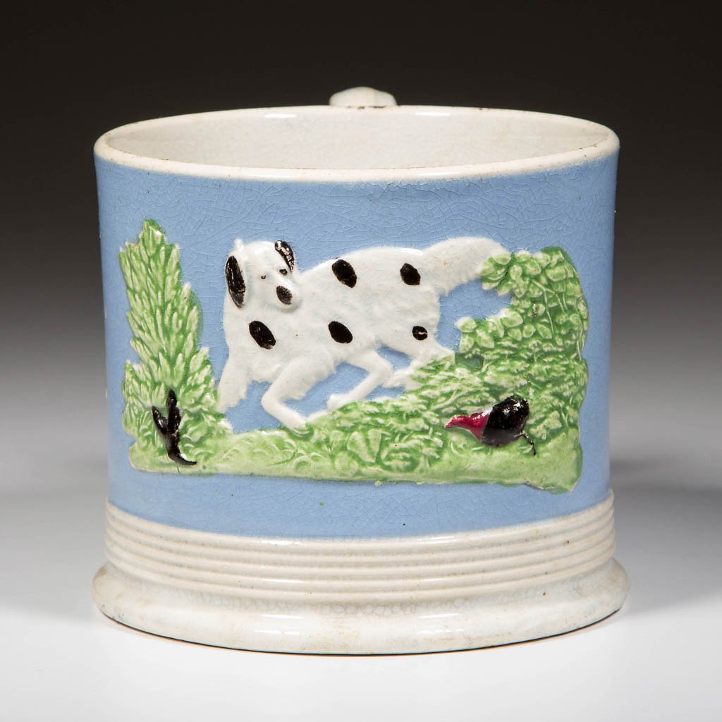 ENGLISH STAFFORDSHIRE POTTERY PEARLWARE PRATTWARE MUG: ENGLISH STAFFORDSHIRE POTTERY PEARLWARE PRATTWARE MUG, of straight-sided form, with ribbed band at lower body over foot, with C-scroll form handle, the body dipped in blue slip with rim and foot wiped