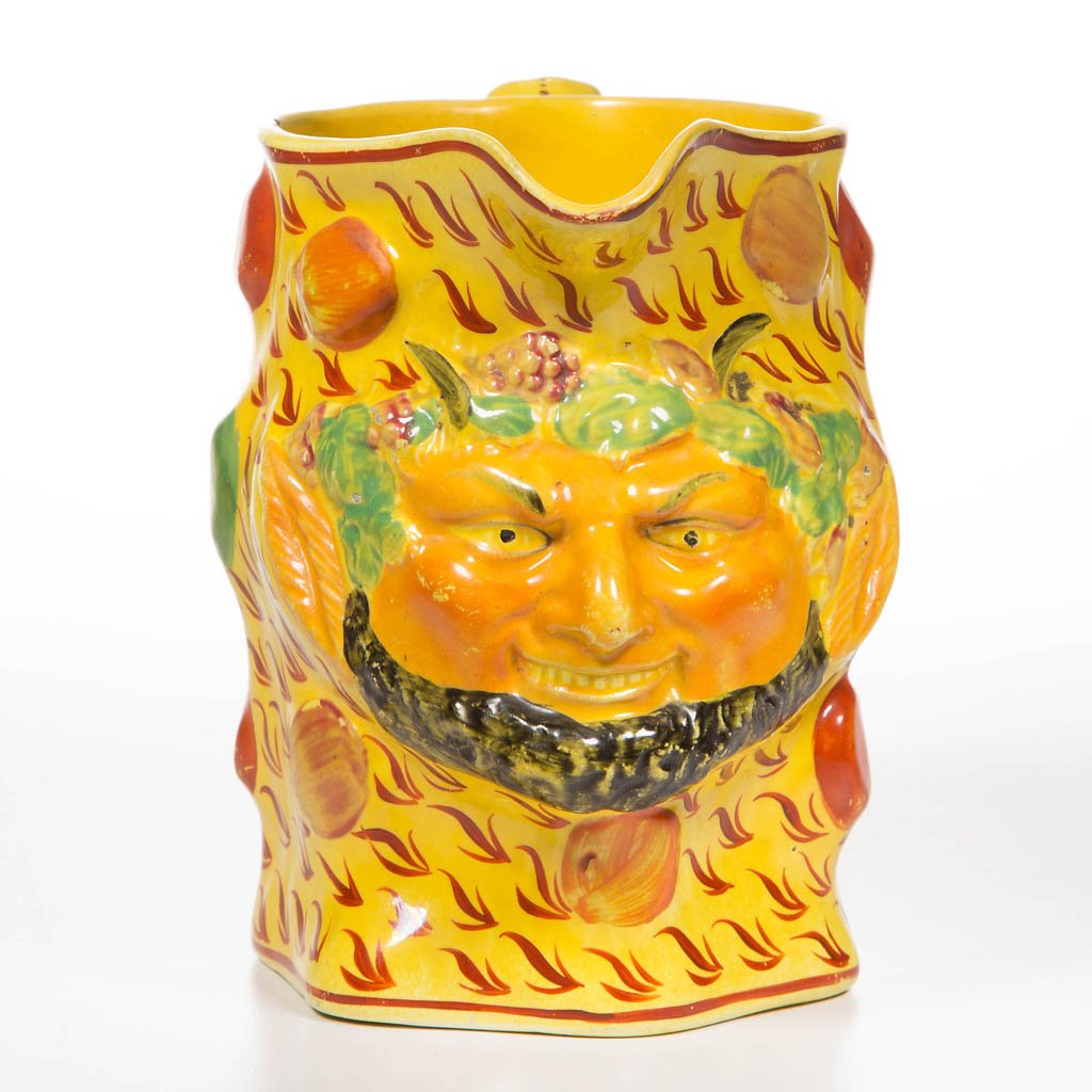 ENGLISH STAFFORDSHIRE POTTERY PEARLWARE CANARY YELLOW: ENGLISH STAFFORDSHIRE POTTERY PEARLWARE CANARY YELLOW BACCHUS PITCHER, of hexagonal form, the body in the form of Bacchus' head, molded with grape clusters and leaves and horns atop his forehead, and