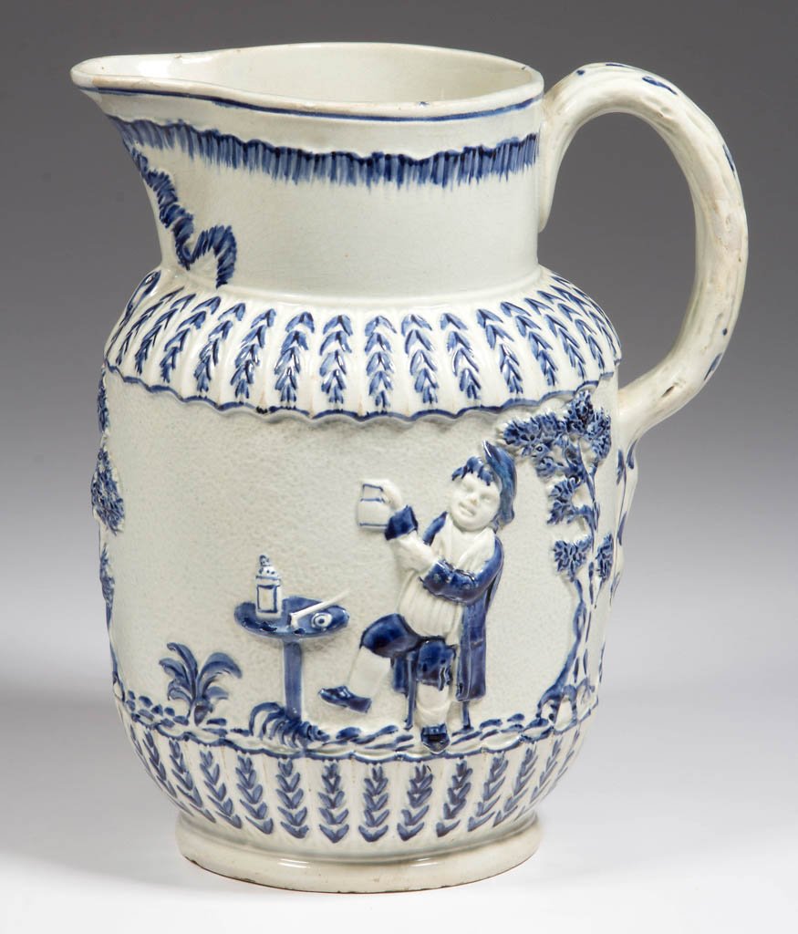 ENGLISH STAFFORDSHIRE POTTERY PEARLWARE PRATTWARE: ENGLISH STAFFORDSHIRE POTTERY PEARLWARE PRATTWARE MOLDED PITCHER, of elongated form, extensively molded with shell-edged band on neck and below spout, with peplum molding at wide band border, the wide