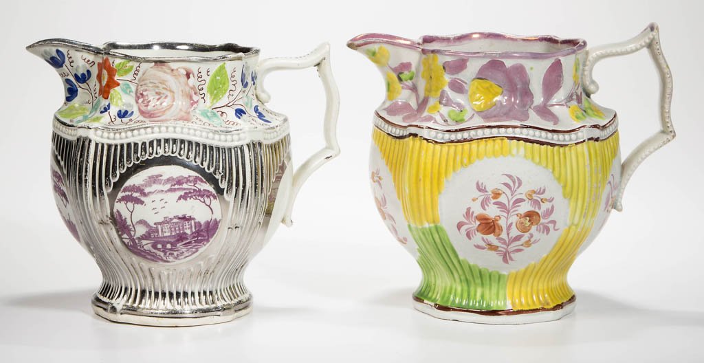 ENGLISH STAFFORDSHIRE POTTERY PEARLWARE MOLDED AND: ENGLISH STAFFORDSHIRE POTTERY PEARLWARE MOLDED AND LUSTERED PITCHERS, LOT OF TWO, each molded identically with four corners on the rounded rectangular mouth, with a band of flowers over the baluster f