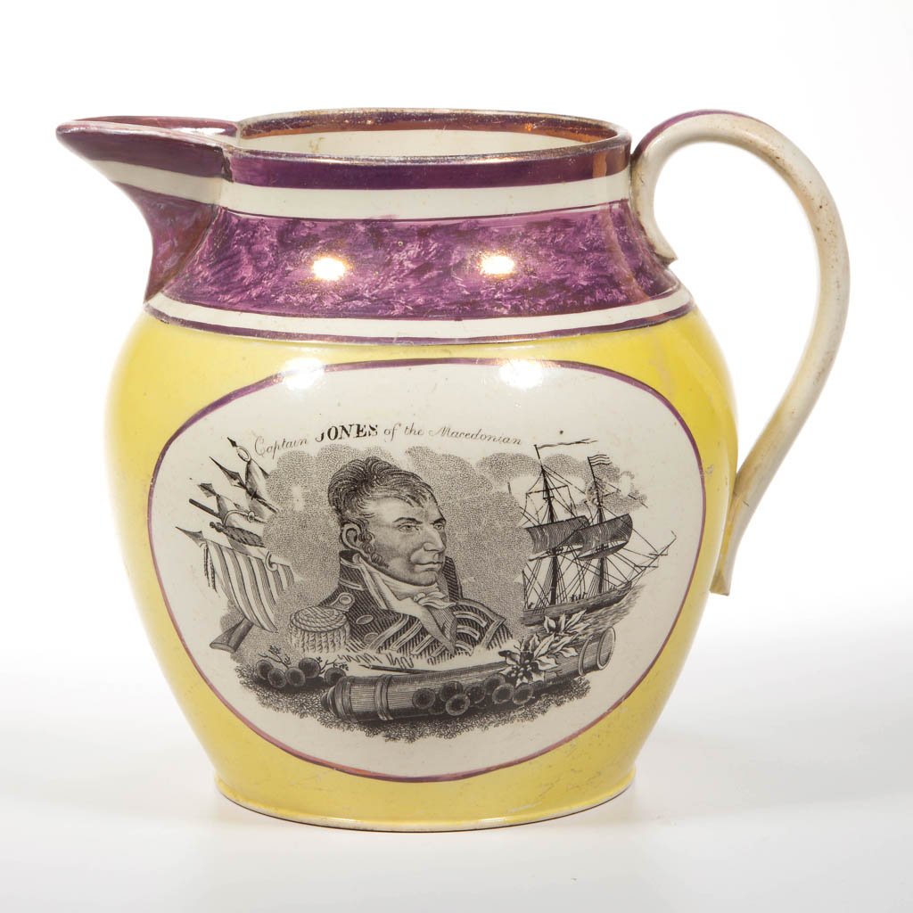 ENGLISH STAFFORDSHIRE PINK LUSTER POTTERY CREAMWARE: ENGLISH STAFFORDSHIRE PINK LUSTER POTTERY CREAMWARE "CAPTAIN JONES" COMMEMORATIVE PITCHER, of Dutch shape with flared neck, painted with luster bands at rim, neck and handle, and on yellow-ground band