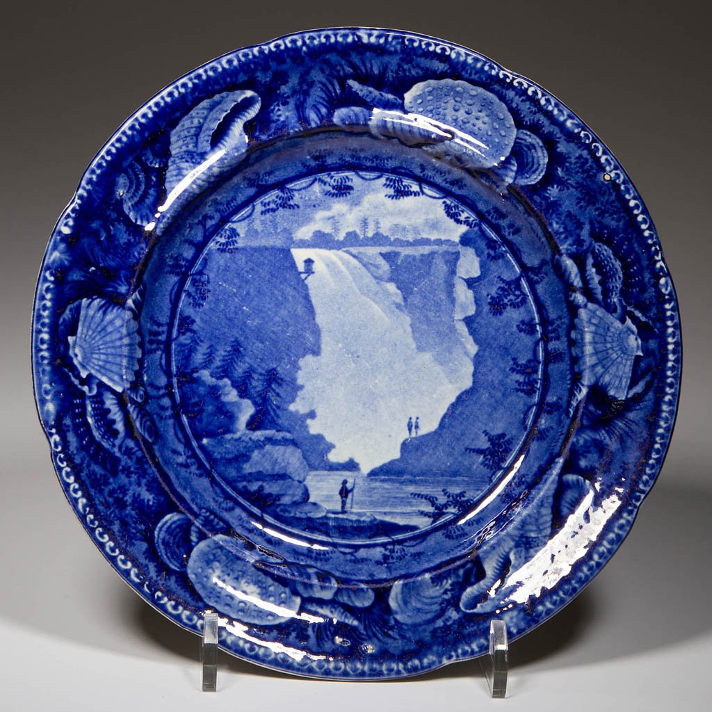 ENGLISH ENOCH WOOD & SONS POTTERY PEARLWARE "FALL OF: ENGLISH ENOCH WOOD & SONS POTTERY PEARLWARE "FALL OF MONTMORENCI NEAR QUEBEC" PATTERN PLATE, transfer-printed in dark blue, the lobed rim and lightly-incurvate shoulder with a dentil edge over a broad