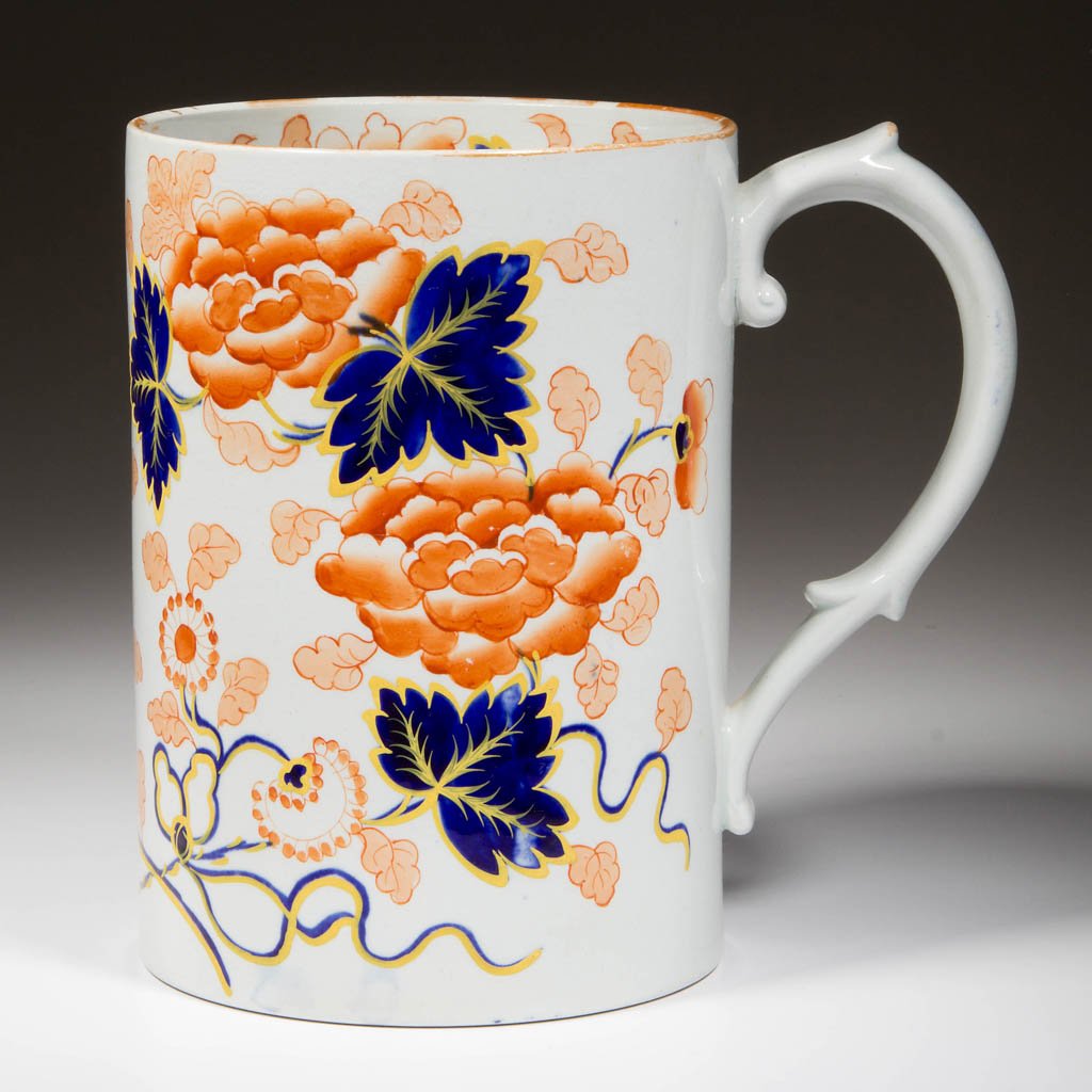 ENGLISH IRONSTONE POTTERY TALL TANKARD: ENGLISH IRONSTONE POTTERY TALL TANKARD, of slightly flaring straight-sided, cylindrical form, the sides printed and painted in Imari palette with peonies, flowering foliage and scrolling vines of bold