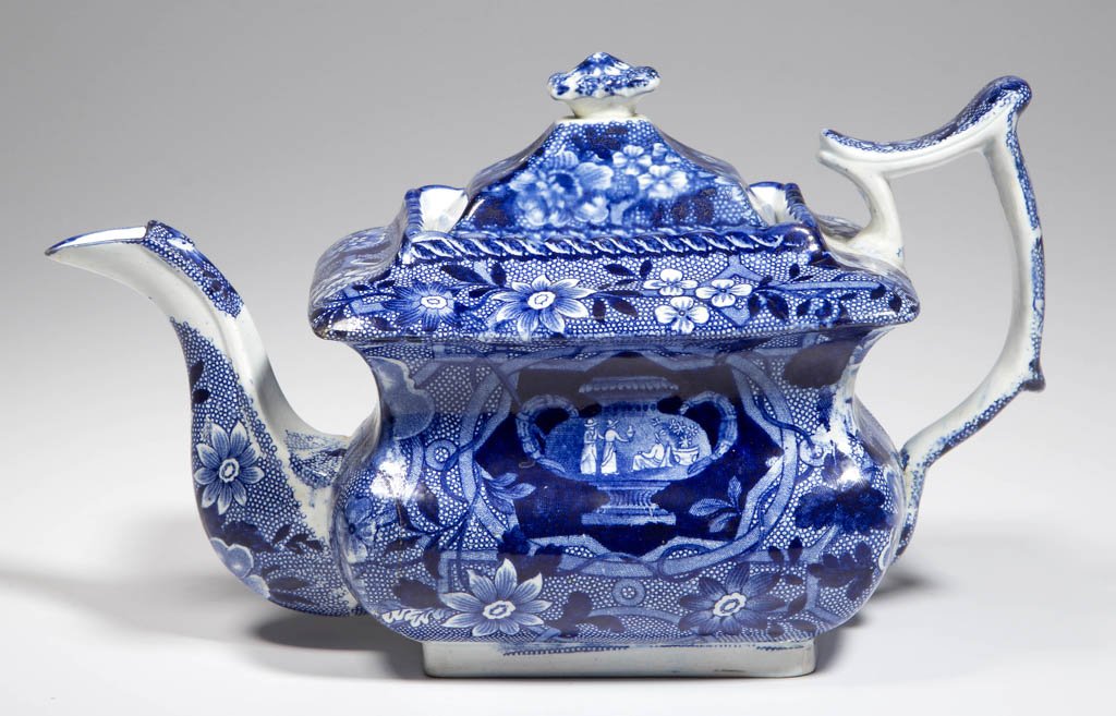 ENGLISH STAFFORDSHIRE POTTERY PEARLWARE: ENGLISH STAFFORDSHIRE POTTERY PEARLWARE TRANSFER-PRINTED TEAPOT AND COVER, of rectangular, hour-glass-molded form, with a broad shoulder and scalloped collar, the high-domed cover with scallop-molded