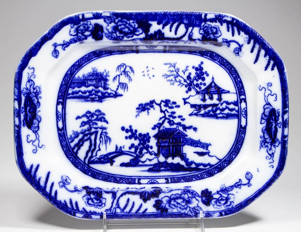 ENGLISH CHARLES MEIGH & SONS IRONSTONE "HONG KONG": ENGLISH CHARLES MEIGH & SONS IRONSTONE "HONG KONG" PATTERN FLOW BLUE PLATTER, of canted-corner, rectangular form, with the cell-and-diaper, trees and foliate border, surrounding the Chinese-inspired v