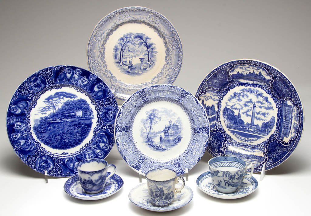 ENGLISH STAFFORDSHIRE POTTERY AND PORCELAIN FLOW BLUE: ENGLISH STAFFORDSHIRE POTTERY AND PORCELAIN FLOW BLUE TABLE ARTICLES, LOT OF TEN, comprising a Wood & Son "Catskill Mountain House" and "A Souvenir of Baltimore" in dark flow blue; a "Venus" and a "Ti
