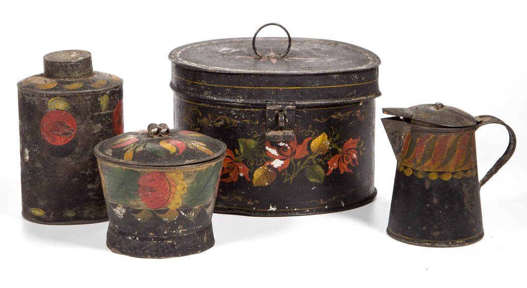 AMERICAN PAINT-DECORATED TOLE ARTICLES, LOT OF FOUR: AMERICAN PAINT-DECORATED TOLE ARTICLES, LOT OF FOUR, polychrome on a black surface, comprising a cream pitcher with hinged lid, a sugar/spice bowl with cover, an oval canister with cover, and oval box
