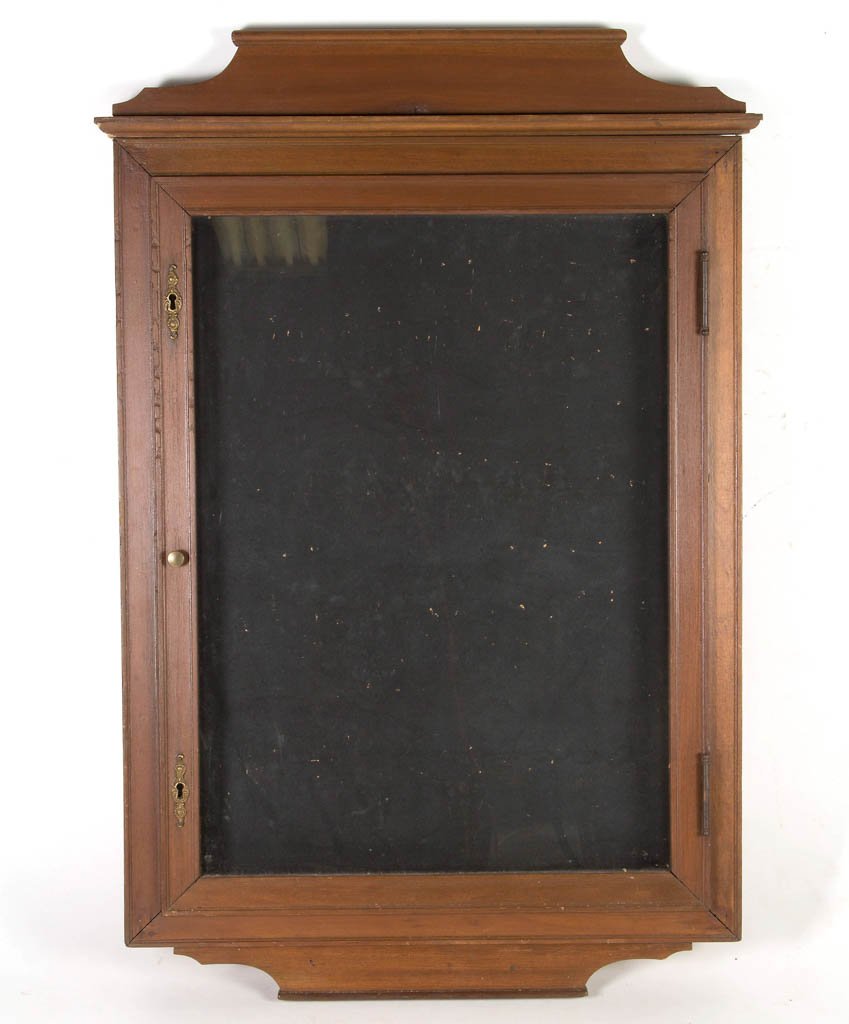 AMERICAN WATCHMAKER'S WALL DISPLAY CASE: AMERICAN WATCHMAKER'S WALL DISPLAY CASE, softwood, with single hinged door and shallow interior for hanging pocket watches. Late 19th/early 20th century. 37" x 25".Provenance: From the Ed & Kay Winnic