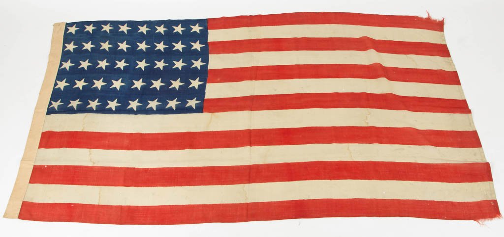 RARE 40-STAR AMERICAN PARADE FLAG: RARE 40-STAR AMERICAN PARADE FLAG, glazed cotton muslin, printed with hand-stitched elements, inscribed "Dr. Crawford" in two places along edge. A copy of a 2006 article on Dr. John B. Crawford publis