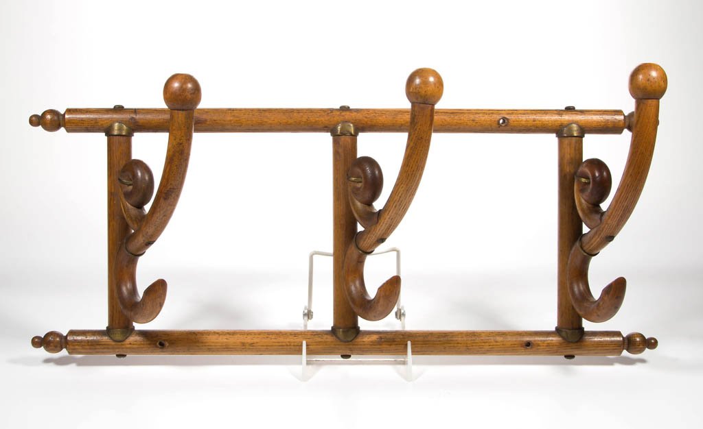 AMERICAN VICTORIAN OAK HANGING HAT RACK: AMERICAN VICTORIAN OAK HANGING HAT RACK, with folding hat hooks and fitted with brass collars at joints, marked with "1892" patent date. Fine old estate surface with warm color. Late 19th century. 22 
