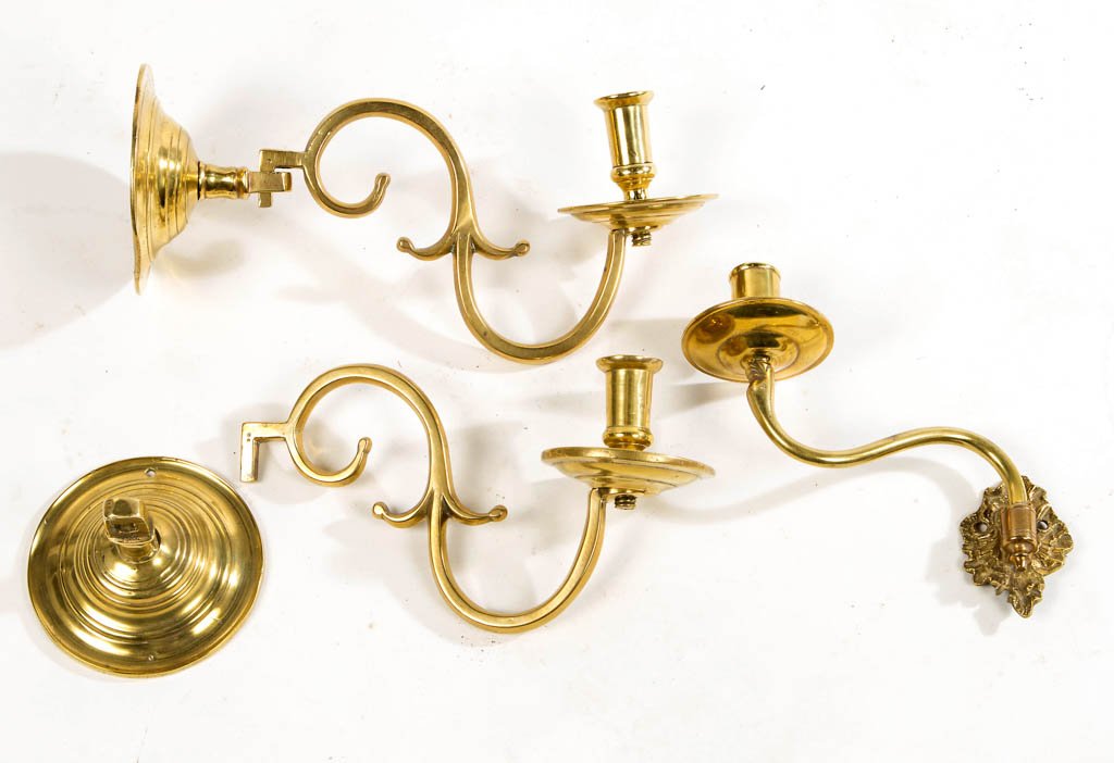 PAIR OF GEORGIAN BRASS WALL SCONCES: PAIR OF GEORGIAN BRASS WALL SCONCES, each having cylindrical socket with flared rim over a circular drip pan, extended on a spurred double C-scroll arm attached to domed wall mounting. Together with a