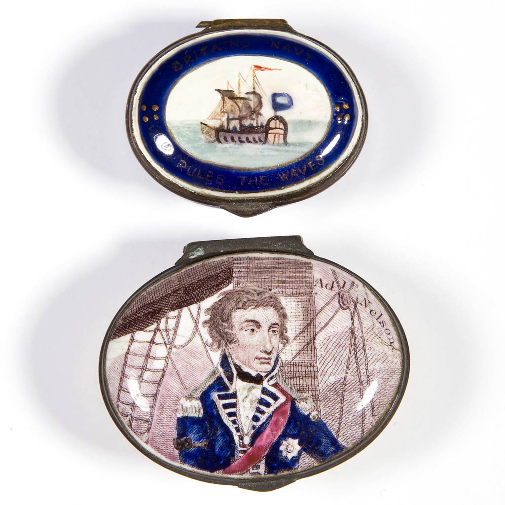 BATTERSEA / BILSTON ENAMEL SNUFF / PILL BOXES, LOT OF: BATTERSEA / BILSTON ENAMEL SNUFF / PILL BOXES, LOT OF TWO, each of oval form with hinged lid, one featuring Admiral Nelson on a ship, the other a ship surrounded by "Britains Navy / Rules the Waves", 