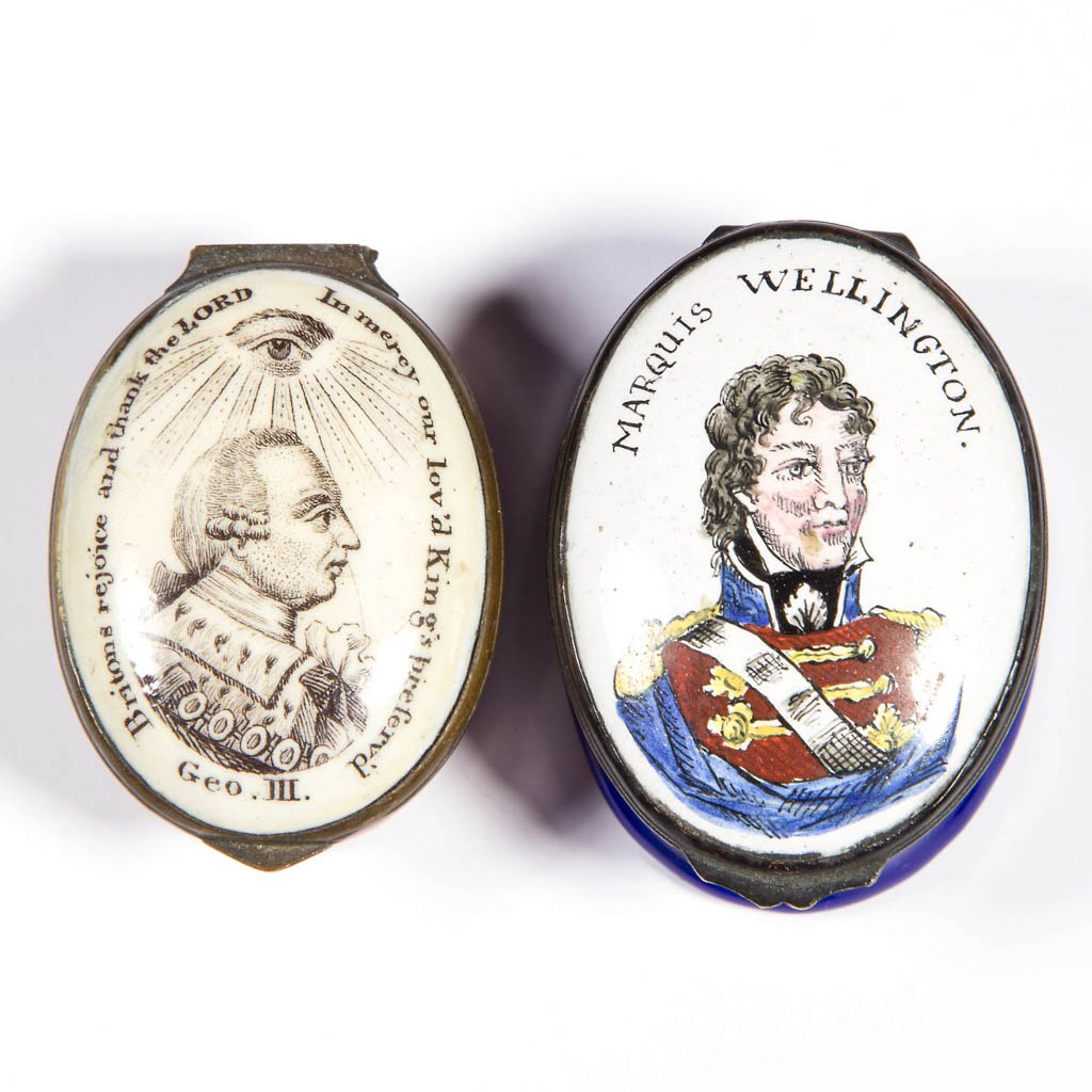 BATTERSEA / BILSTON ENAMEL SNUFF / PILL BOXES, LOT OF: BATTERSEA / BILSTON ENAMEL SNUFF / PILL BOXES, LOT OF TWO, each of oval form with hinged lid, one featuring a portrait of George III under a seeing eye, the other Marquis Wellington, first with a mirr