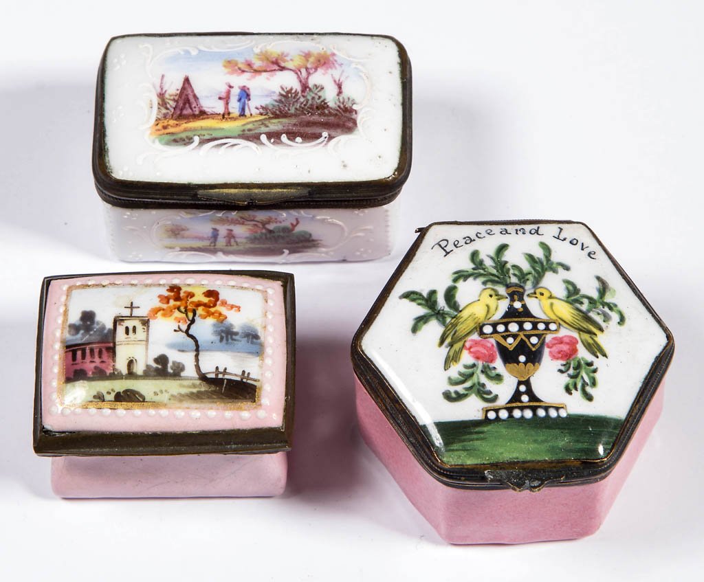 BATTERSEA / BILSTON ENAMEL SNUFF / PILL BOXES, LOT OF: BATTERSEA / BILSTON ENAMEL SNUFF / PILL BOXES, LOT OF THREE, each of square or hexagonal form with hinged lid, one featuring "Peace and Love" above an urn with birds and flowers, one with a landscape 
