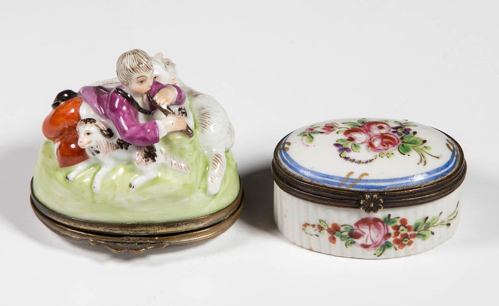 CONTINENTAL PORCELAIN SNUFF BOXES, LOT OF TWO: CONTINENTAL PORCELAIN SNUFF BOXES, LOT OF TWO, comprising a figural example featuring a shepherd, his dog, and two sheep in high relief, with floral decoration under base, and an oval example with flo