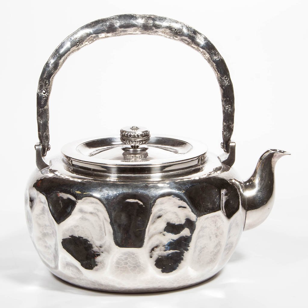 JAPANESE ARTS & CRAFTS STYLE SILVER TEAPOT: JAPANESE ARTS & CRAFTS STYLE SILVER TEAPOT, hammered wrought style with hollow swing handle. Japanese hallmark along with what appears to be a Persian hallmark. Total weight: 23.33 ozt. Late 19th/earl