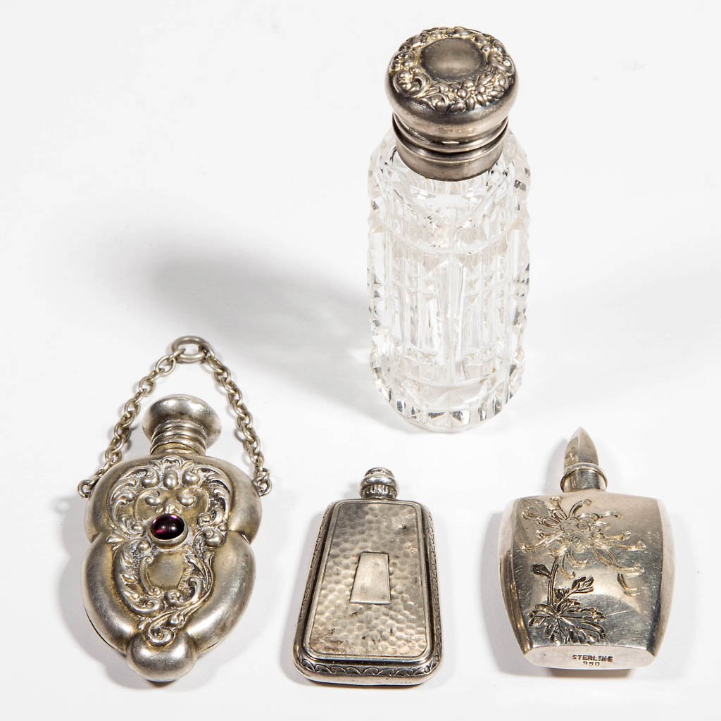 ASSORTED STERLING SILVER SCENT BOTTLES, LOT OF FOUR: ASSORTED STERLING SILVER SCENT BOTTLES, LOT OF FOUR, including one small cut glass bottle with hinged silver-plated top, and three small scent bottles marked for sterling, all with original caps. Late