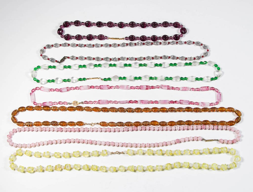 ASSORTED GLASS-BEAD NECKLACES, LOT OF SEVEN: ASSORTED GLASS-BEAD NECKLACES, LOT OF SEVEN, various solid and striped colors, one with gilt highlights. 20th century. Various sizes. Provenance: Nadene J. Stockard estate collection, Alexandria, VA.