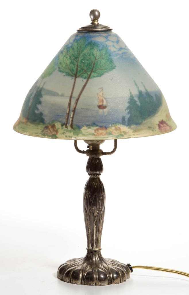 PAIRPOINT REVERSE-PAINTED SCENIC SHADE BOUDOIR LAMP: PAIRPOINT REVERSE-PAINTED SCENIC SHADE BOUDOIR LAMP, conical-form shade signed "The Pairpoint Corp.,", depicting a sailing scene on the edge of the forest, silver-plate Art Nouveau base with a single 