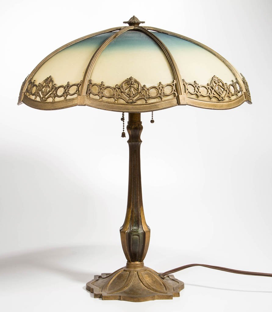 PANELED GLASS METAL TABLE LAMP: PANELED GLASS METAL TABLE LAMP, eight-panel umbrella-form shade, with applied metal decoration, metal Art Nouveau base with three sockets, not signed. Circa 1920s. 21 1/4" HOA, shade 18 1/2" D.Provena