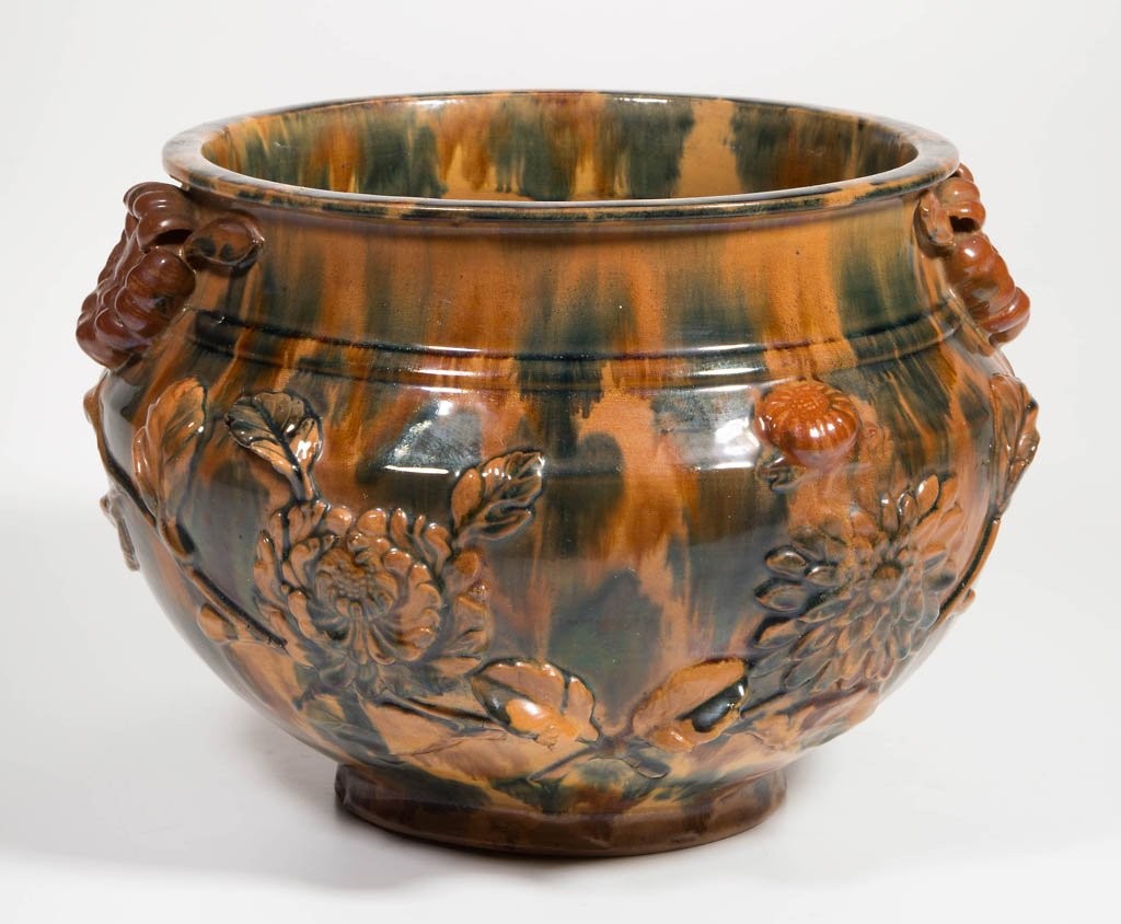 ART POTTERY EARTHENWARE JARDINIÃˆRE: ART POTTERY EARTHENWARE JARDINIÃˆRE, lead-glazed, polychrome, with molded and applied floral blossoms and foliage. Unmarked. Late 19th/early 20th century. 7 3/8" H, 8 1/2" D rim.
