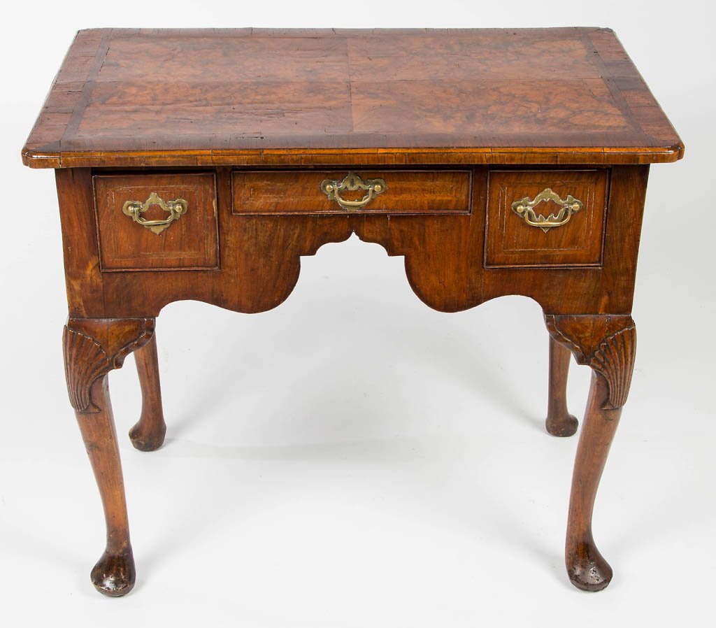 GEORGE II CARVED BURL WALNUT DRESSING TABLE: GEORGE II CARVED BURL WALNUT DRESSING TABLE, in the Queen Anne style, the rectangular top having molded edge and notched corners over three inlaid drawers with cockbeaded edges set into a shaped skirt