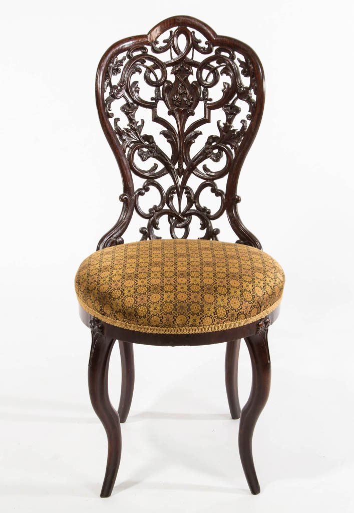 AMERICAN VICTORIAN CARVED ROSEWOOD LAMINATED SLIPPER: AMERICAN VICTORIAN CARVED ROSEWOOD LAMINATED SLIPPER CHAIR, the pierced back with foliate and floral designs over an upholstered seat raised on curvilinear, bandy-type legs, in the manner of John Henr