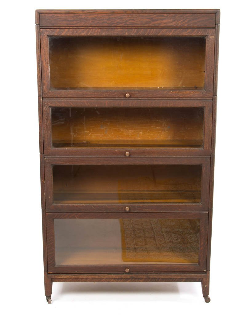 AMERICAN QUARTER-SAWN OAK SECTIONAL BOOKCASE: AMERICAN QUARTER-SAWN OAK SECTIONAL BOOKCASE, in an Arts and Crafts style, in four sections, and on a separate frame. Original label for the Gunn Manufacturing Co. (Grand Rapids, MI, 1893 - 1953). Old
