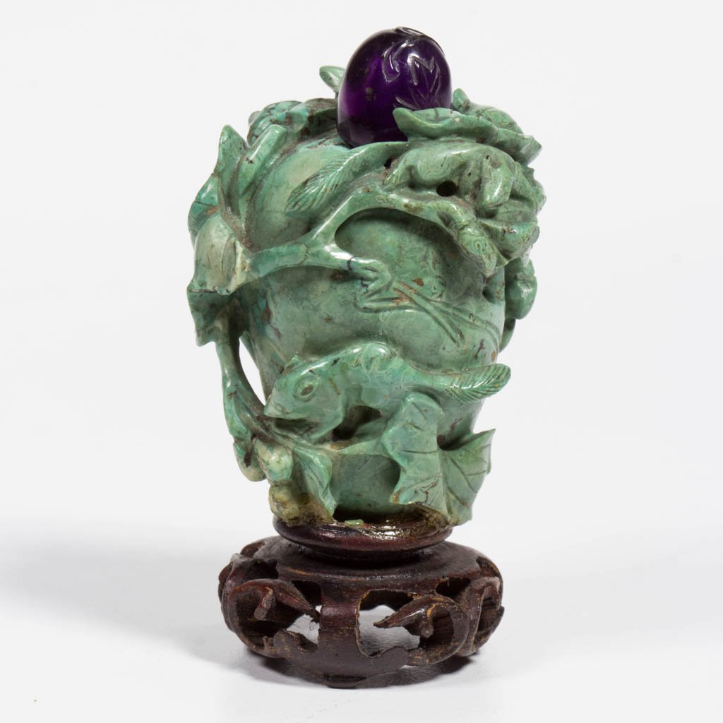 CHINESE CARVED SOAPSTONE SNUFF BOTTLE WITH PURPLE: CHINESE CARVED SOAPSTONE SNUFF BOTTLE WITH PURPLE QUARTZ STOPPER, the body formed as a tapering urn, within elaborate carved vining foliage with squirrels and mice hidden among the leafy branches. Unm