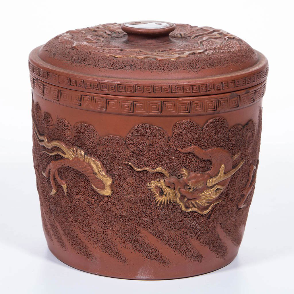 CHINESE EARTHENWARE JAR WITH COVER: CHINESE EARTHENWARE JAR WITH COVER, Yixing-style, of tapering, near-cylindrical form, the body decorated in incised and molded relief with dragon in flight through clouds, and band of Greek key to col