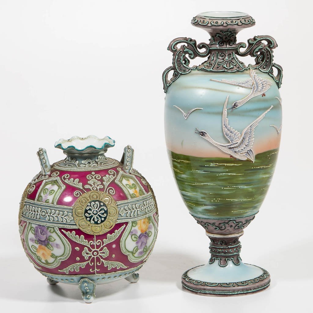 ROYAL NIPPON MORIAGE VASES, LOT OF TWO: ROYAL NIPPON MORIAGE VASES, LOT OF TWO, comprising one urn form on bolted pedestal foot, with elaborate handles rising from shoulders, decorated with geese in flight over water; and one spherical form