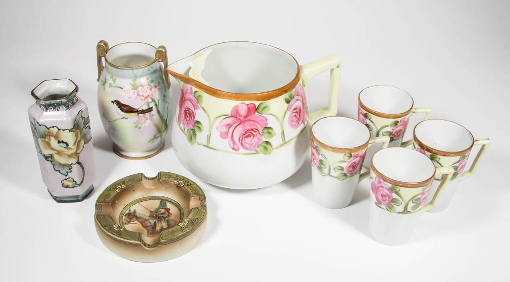 ASSORTED NIPPON PORCELAIN ARTICLES, LOT OF EIGHT: ASSORTED NIPPON PORCELAIN ARTICLES, LOT OF EIGHT, comprising a five-piece cider set, a handled urn-form vase, a straight-sided hexagonal vase and an Moriage ashtray with a centered image of a Middle E