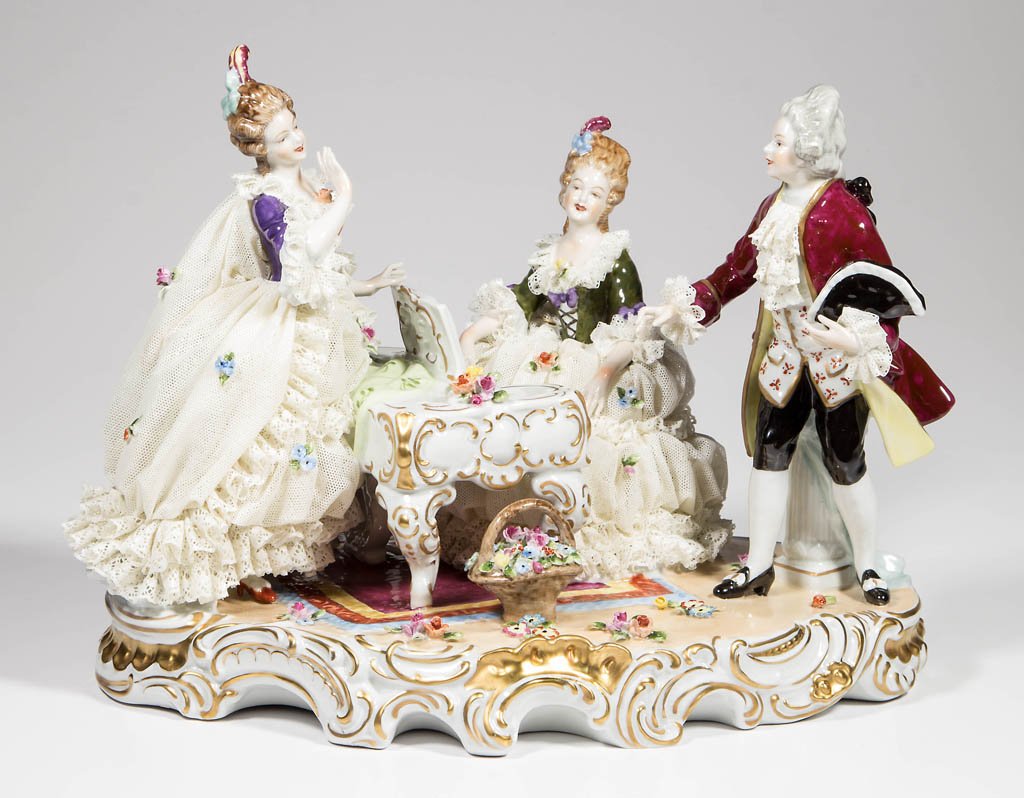 DRESDEN-LACE GERMAN PORCELAIN LARGE FIGURAL GROUP: DRESDEN-LACE GERMAN PORCELAIN LARGE FIGURAL GROUP, depicting a lady seated at a piano flanked by a female and male dancer, on an oval base with flower basket. Medium blue crown over "V.E.B." and "Unte