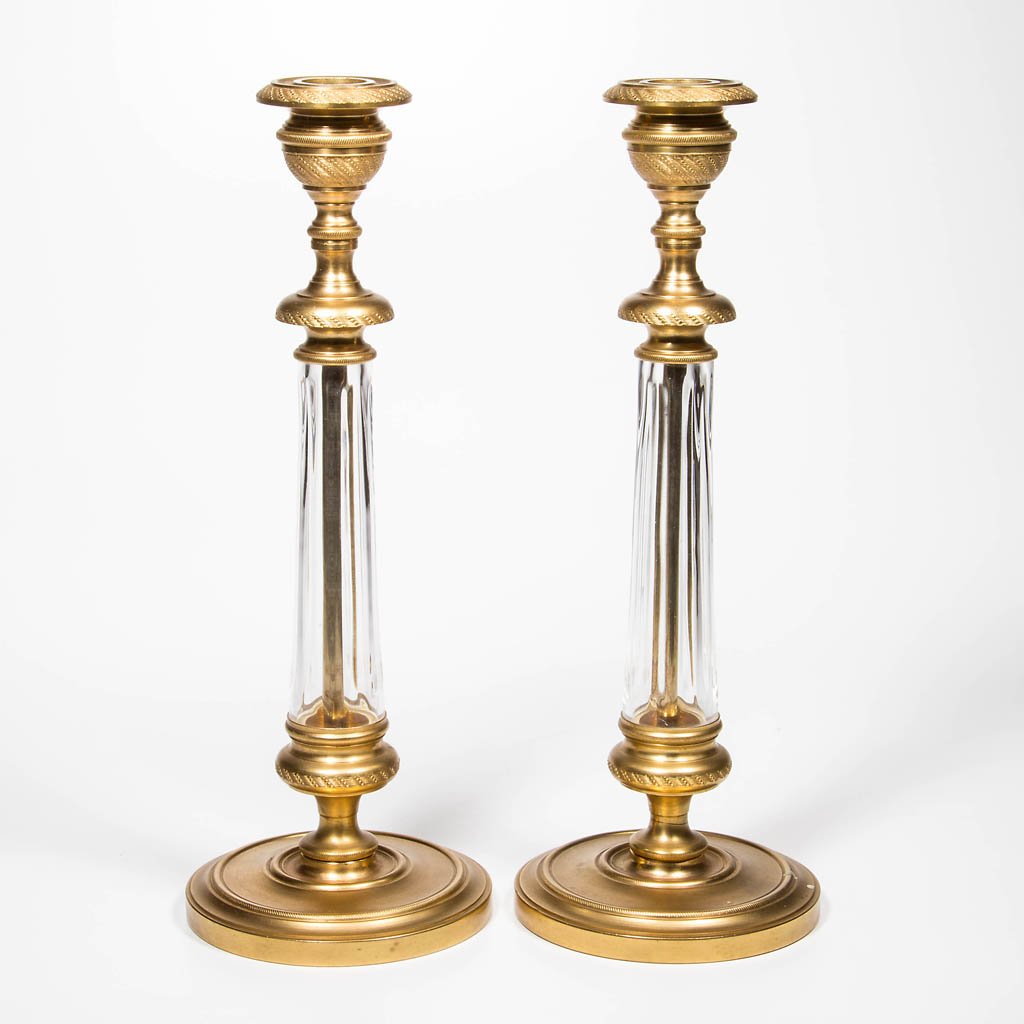 BACCARAT, FRANCE CRYSTAL AND ORMOLU MOUNTED PAIR OF: BACCARAT, FRANCE CRYSTAL AND ORMOLU MOUNTED PAIR OF CANDLESTICKS, lightly ribbed colorless glass stems with scratched "Baccarat" signature. 20th century. 10 1/2" H.