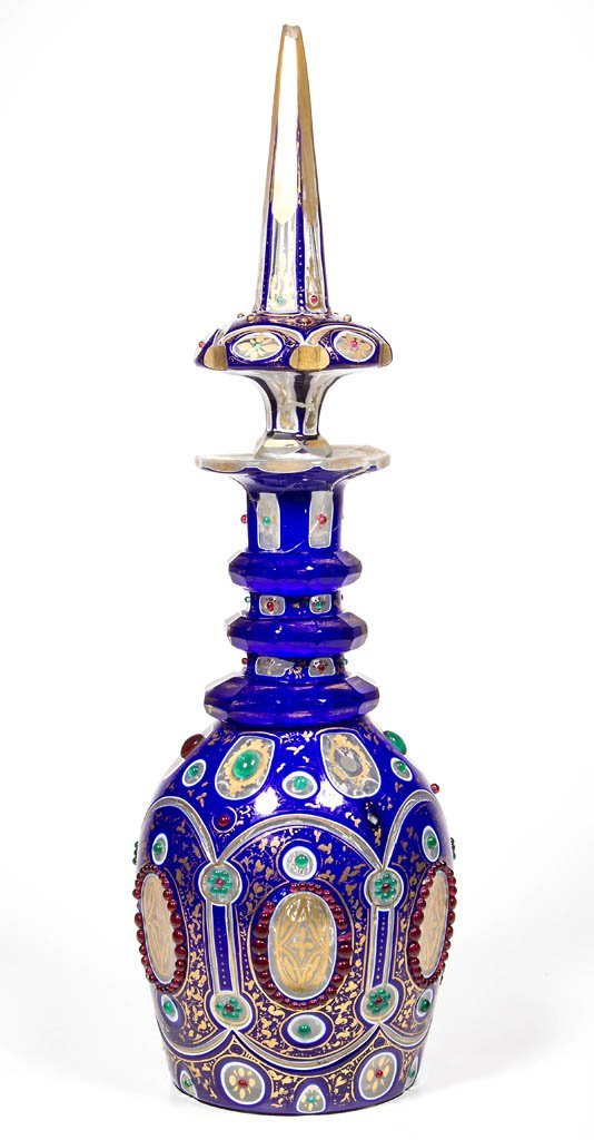 BOHEMIAN JEWELED CUT DOUBLE OVERLAY DECANTER: BOHEMIAN JEWELED CUT DOUBLE OVERLAY DECANTER, deep blue to white to colorless with gilt decorations and applied red and green jewels, Prussian form with three facet-cut neck rings and polished pontil 