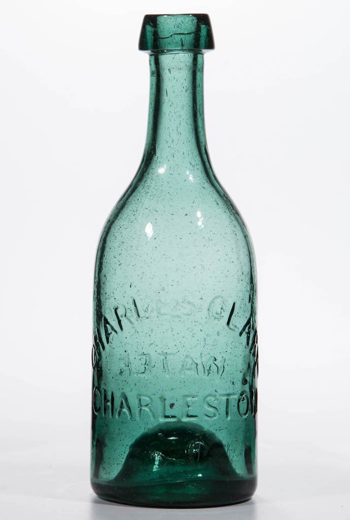 SOUTH CAROLINA SODA BOTTLE: SOUTH CAROLINA SODA BOTTLE, medium green, embossed "CHARLES CLARK / CHARLESTON / S.C." and "SODA / WATER", applied sloping collared mouth, kick-up base with graphite pontil mark. Circa 1850-1860. 7 1/