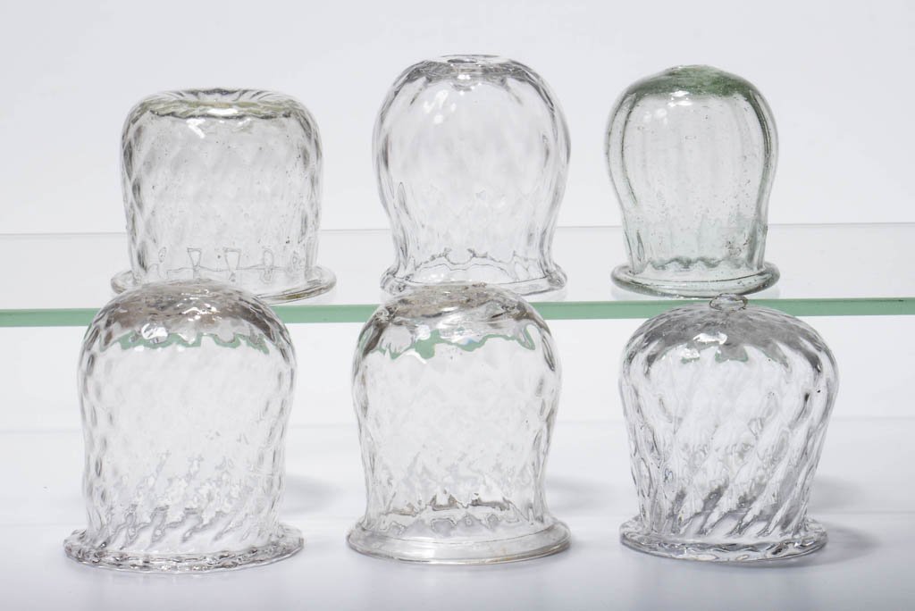 ASSORTED PATTERN-MOLDED CHRISTMAS LIGHTS, LOT OF SIX: ASSORTED PATTERN-MOLDED CHRISTMAS LIGHTS, LOT OF SIX, colorless, comprising five diamond molded and one rib molded with green tint, each with folded rim and rough pontil mark. 19th century. 2 1/4" to 
