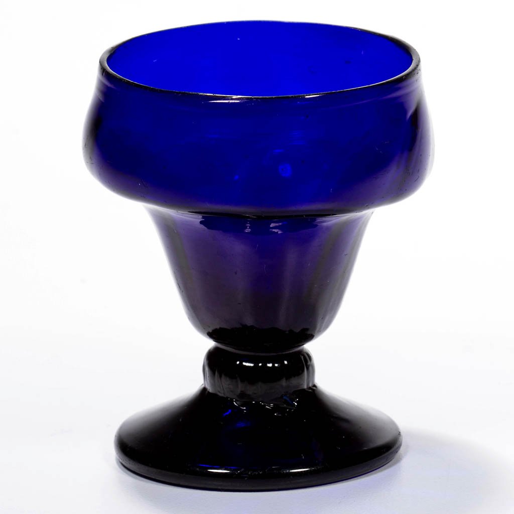 PATTERN-MOLDED RIB FOOTED OPEN SALT: PATTERN-MOLDED RIB FOOTED OPEN SALT, cobalt blue, double-ogee bowl molded with 12 vertical ribs swirled slightly to the right at the rim, raised on a short ribbed stem and an applied circular sloping 