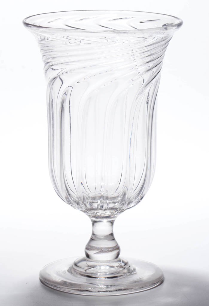 SWIRLED PILLAR-MOLDED VASE OR CELERY GLASS: SWIRLED PILLAR-MOLDED VASE OR CELERY GLASS, colorless, deep bowl with 12 ribs tightly swirled to the right at the plain rim, raised on an applied baluster-form stem and circular foot with a polished p