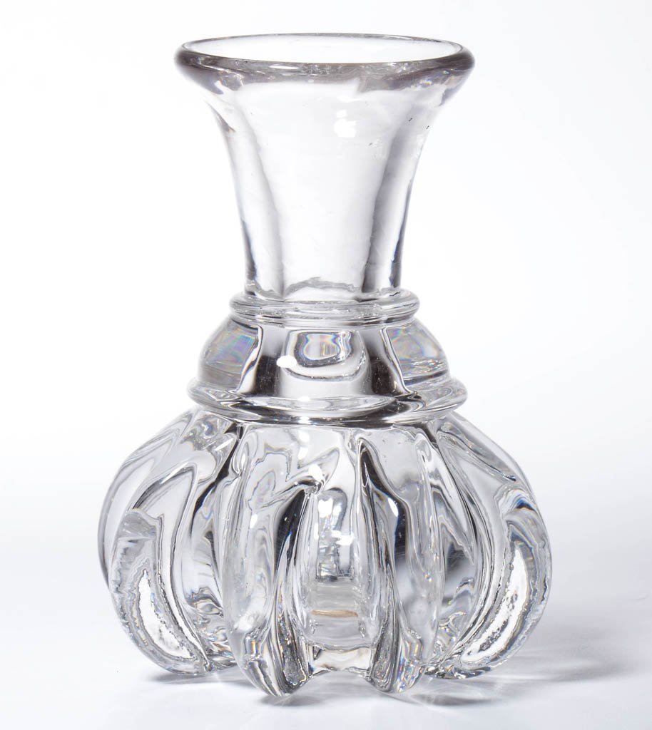 PILLAR-MOLDED MEASURE: PILLAR-MOLDED MEASURE, colorless, squat form with eight pronounced ribs, an applied wide collared neck ring, and a plain flared lip, factory polished ribs to level and pontil mark. Probably England. C