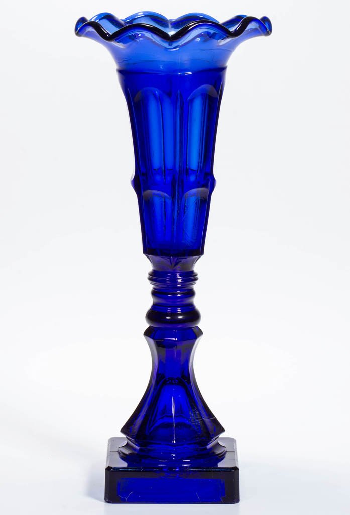 PRESSED BIGLER VASE: PRESSED BIGLER VASE, brilliant deep sapphire blue, deep conical bowl with a gauffered 10-petal rim, raised on a double-knop stem, octagonal baluster-form standard and square base, wafer construction. 