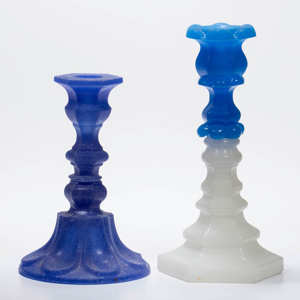 ASSORTED PRESSED CANDLESTICKS, LOT OF TWO: ASSORTED PRESSED CANDLESTICKS, LOT OF TWO, starch blue and medium blue over alabaster/clambroth, each with a sanded surface. comprising a hexagonal thin-lipped example with a loop base and a Mt. Washi