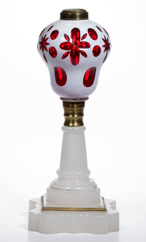 CUT DOUBLE OVERLAY STAR AND PUNTY KEROSENE STAND LAMP: CUT DOUBLE OVERLAY STAR AND PUNTY KEROSENE STAND LAMP, white to ruby-cased colorless pyriform font with additional cuttings of vesicas and elongated panels, alabaster/clambroth Baroque base with later