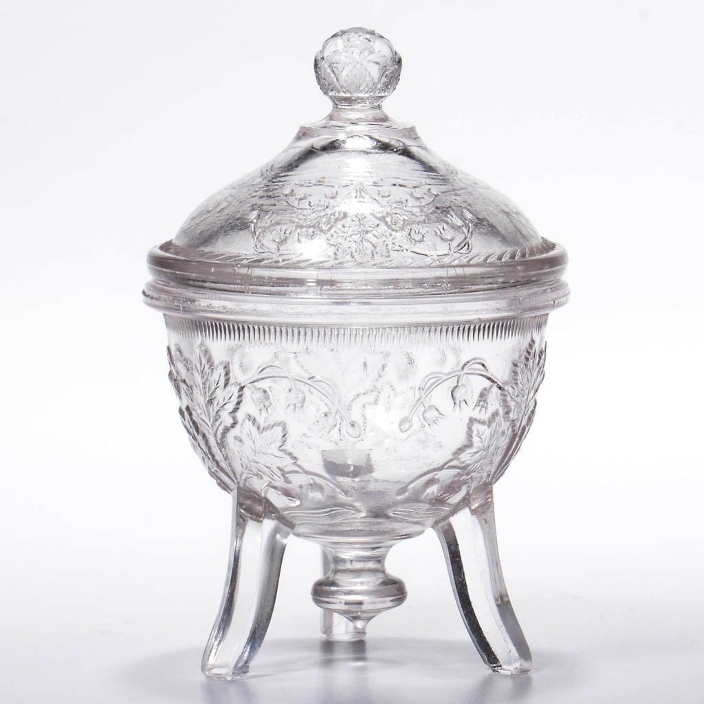 BLEEDING HEART/ FLORAL (OMN) COVERED MASTER SALT: LILY OF THE VALLEY COVERED MASTER SALT, colorless lead glass, raised on three feet with central pendant drop, with matching cover. Fourth quarter 19th century. 4 1/4" HOA. Provenance: Lowell/Lomas col