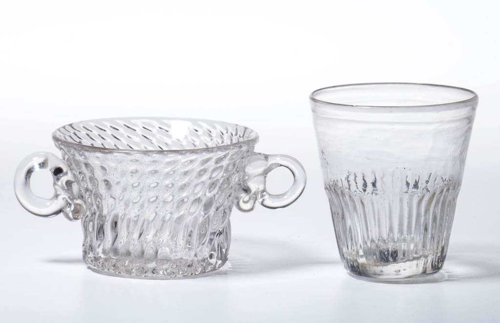 PATTERN-MOLDED TOYS, LOT OF TWO: PATTERN-MOLDED TOYS, LOT OF TWO, colorless, comprising a GI-6 taper tumbler, and a swirled broken rib dish with applied ear-like side handles, each with rough pontil mark. Tumbler possibly Boston & Sa