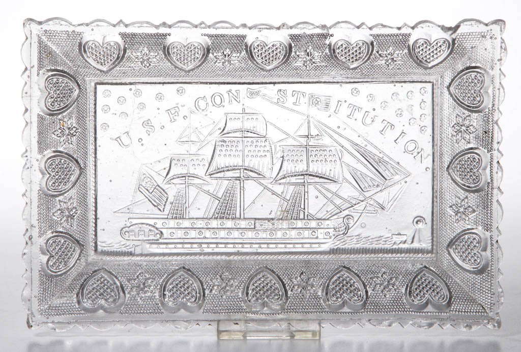 PRESSED LACY "U. S. F. CONSTITUTION" RECTANGULAR TRAY: PRESSED LACY "U. S. F. CONSTITUTION" RECTANGULAR TRAY, colorless, border with alternating hearts and six-point stars, wide-scallop and point rim, double-rope table ring. Boston & Sandwich Glass Co. Ci
