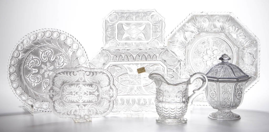 ASSORTED PRESSED LACY ARTICLES, LOT OF SEVEN: ASSORTED PRESSED LACY ARTICLES, LOT OF SEVEN, colorless, including a California covered sugar, Heart and Scale creamer, and two Leaf and Gothic Arch oblong dishes. Boston & Sandwich Glass Co. and othe