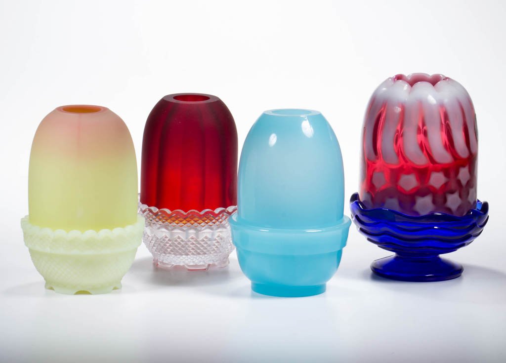 FENTON FAIRY LAMPS, LOT OF FOUR: FENTON FAIRY LAMPS, LOT OF FOUR, comprising a robins egg blue pyramid-size shade with matching lamp cup, a Burmese pyramid-size shade with ill-fitting custard lamp cup, a cased pigeons blood shade wit